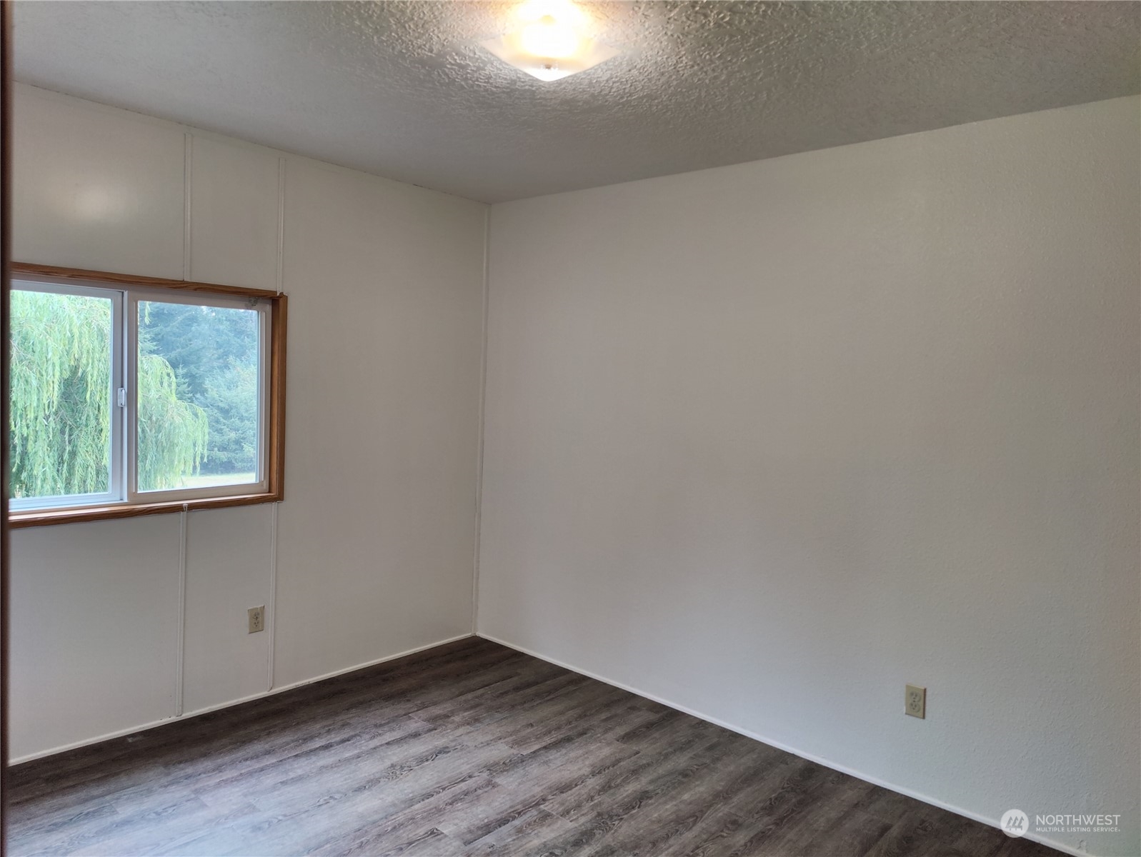 126 Reinseth Road Winlock, WA 98596 - Photo 22 of 33 an empty room with wooden floor and windows