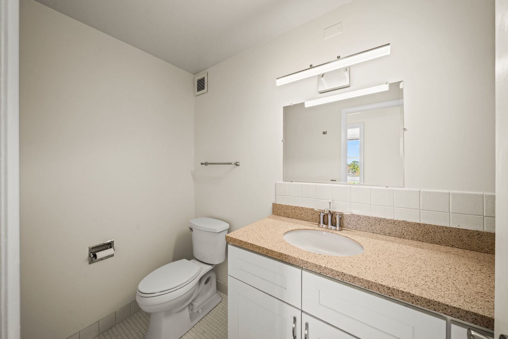 5975 North Odell Avenue, Unit 5C Chicago, IL 60631 - Photo 16 of 20 a bathroom with a granite countertop sink a toilet and a mirror