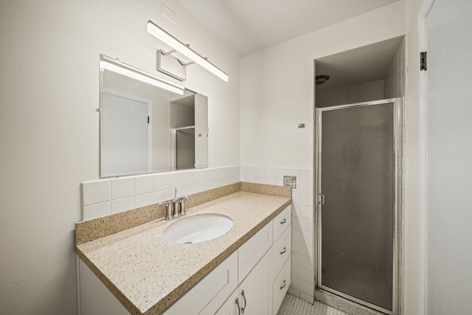 5975 North Odell Avenue, Unit 5C Chicago, IL 60631 - Photo 17 of 20 a bathroom with a sink vanity and a mirror
