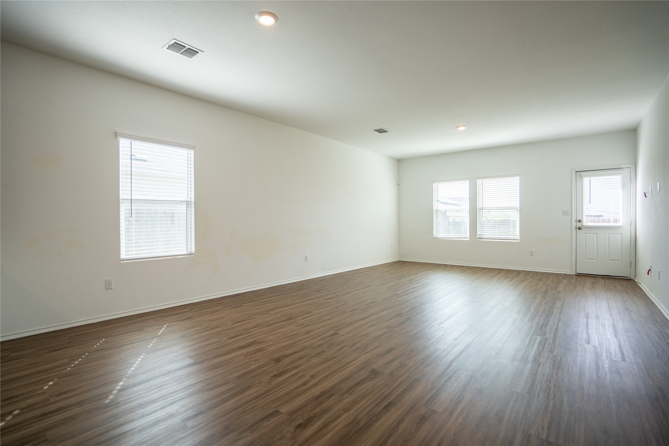 13400 Banquete Street Elgin, TX 78621 - Photo 11 of 29 Spare room featuring dark wood-style floors and recessed lighting