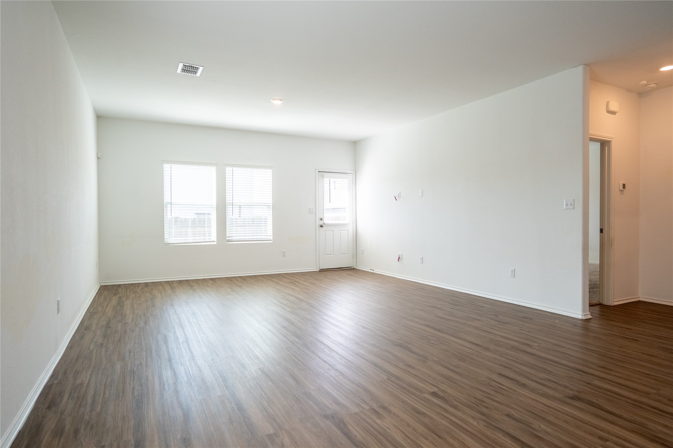 13400 Banquete Street Elgin, TX 78621 - Photo 12 of 29 Unfurnished room with dark wood finished floors and recessed lighting