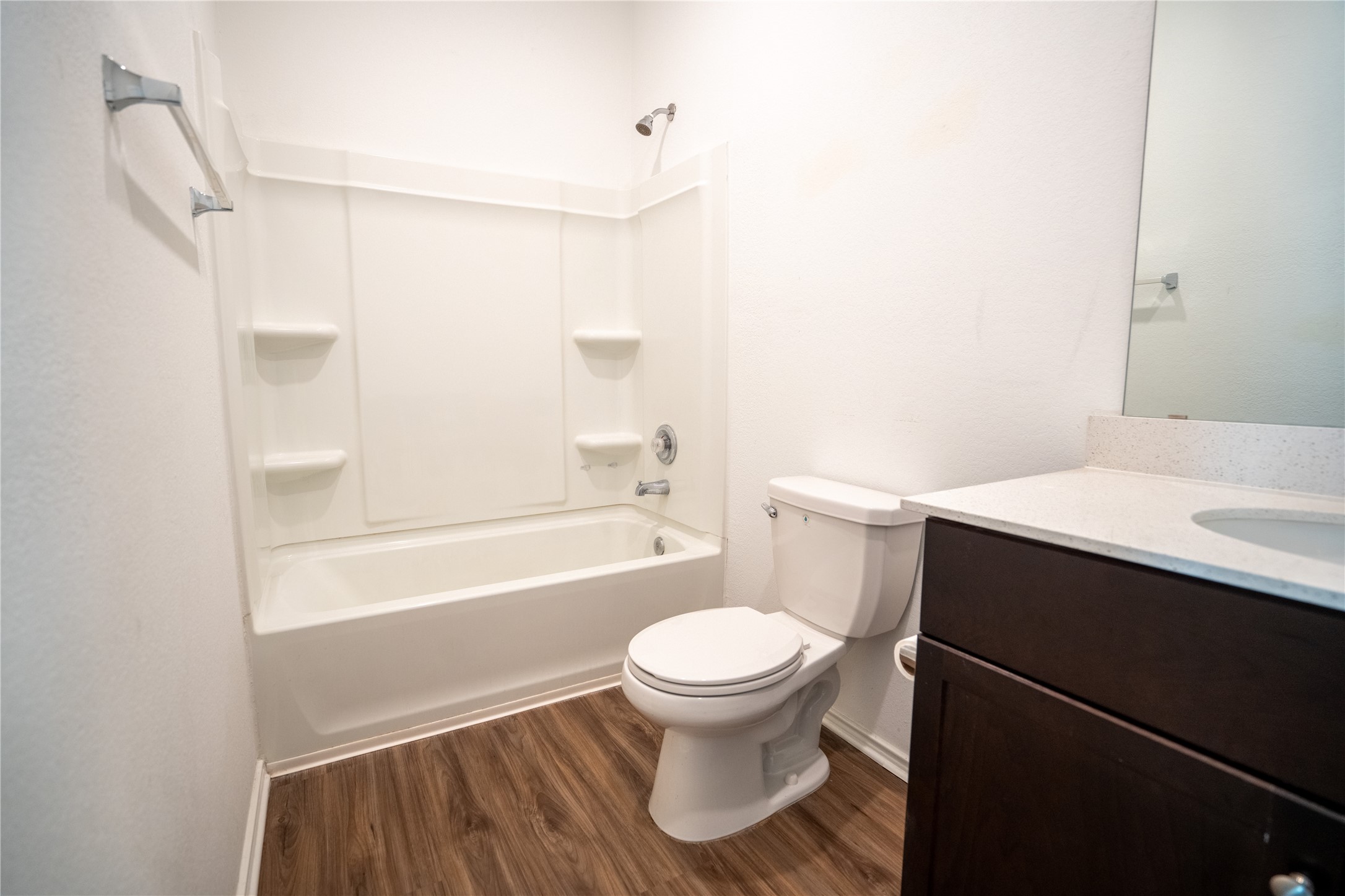 13400 Banquete Street Elgin, TX 78621 - Photo 17 of 29 Bathroom with vanity, dark wood-style flooring, and washtub / shower combination