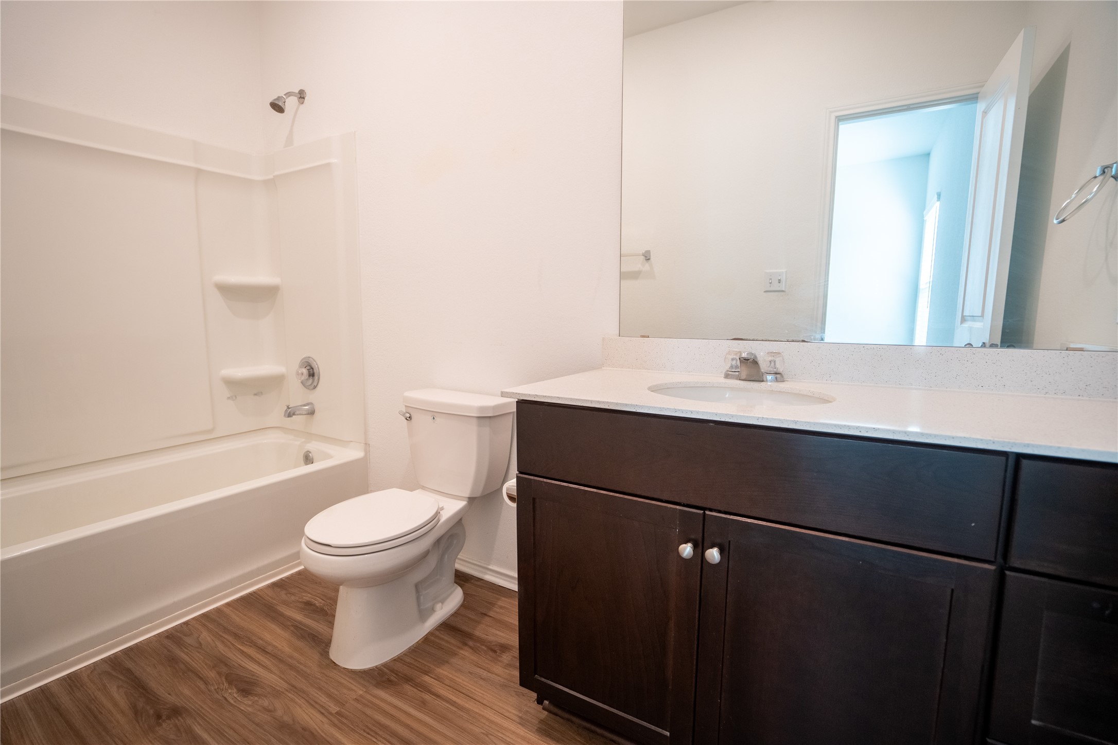 13400 Banquete Street Elgin, TX 78621 - Photo 18 of 29 Bathroom with vanity, dark wood finished floors, and shower / bath combination