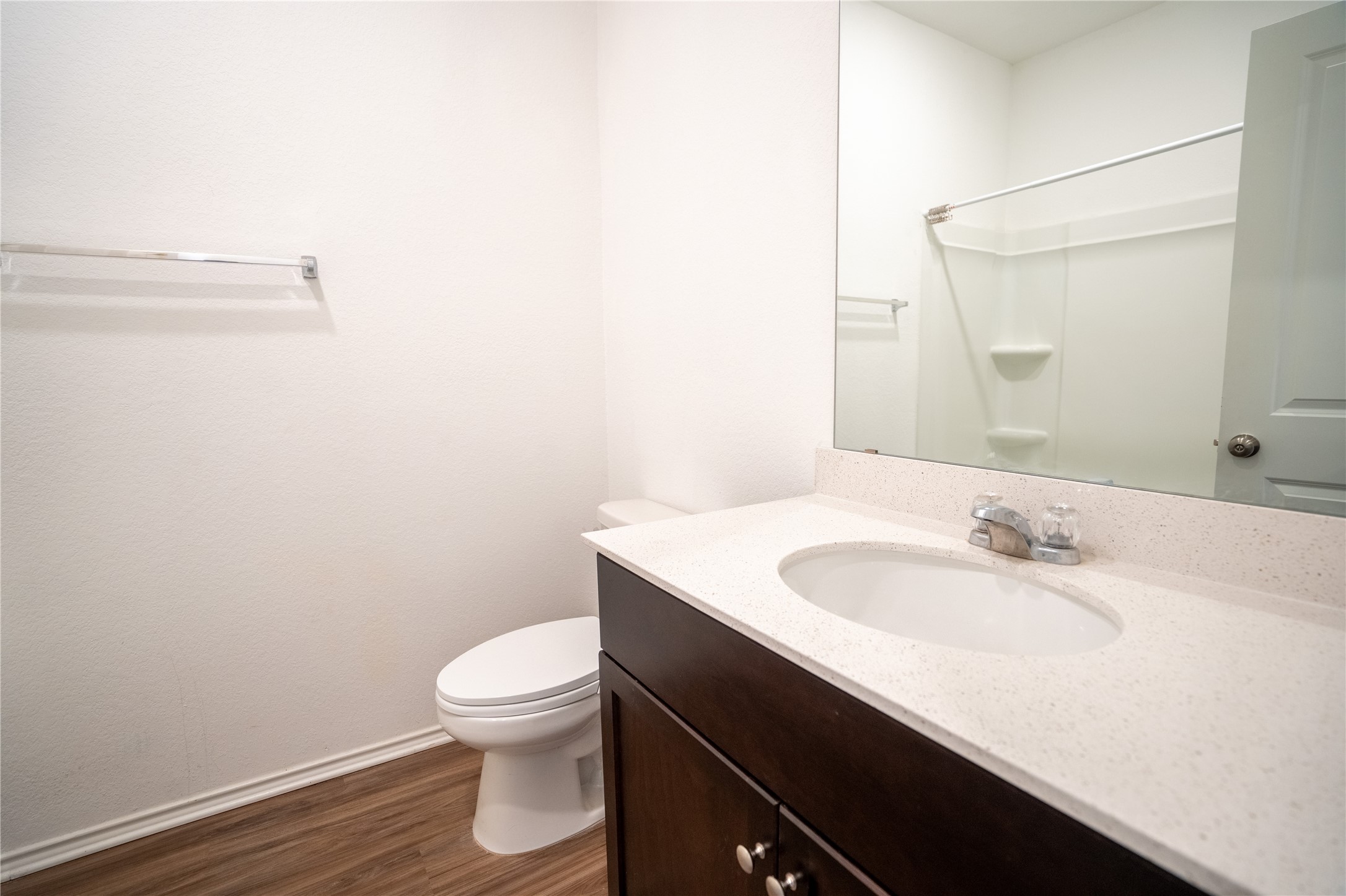 13400 Banquete Street Elgin, TX 78621 - Photo 21 of 29 Full bath featuring vanity, dark wood-style flooring, and a shower