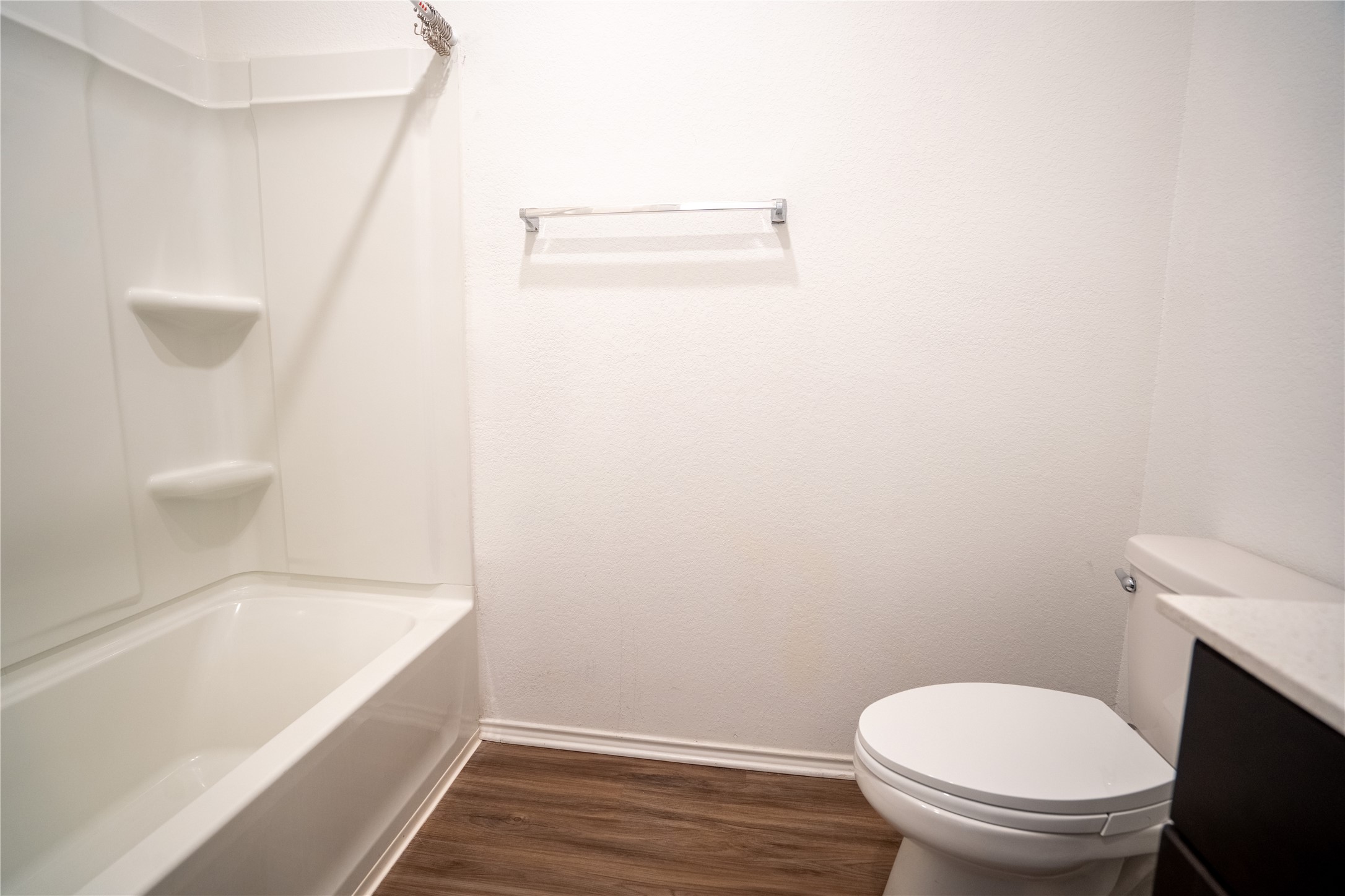 13400 Banquete Street Elgin, TX 78621 - Photo 22 of 29 Bathroom with vanity, dark wood-type flooring, and bathtub / shower combination