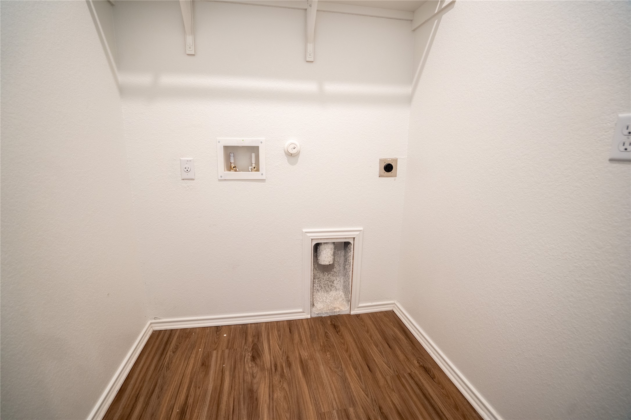 13400 Banquete Street Elgin, TX 78621 - Photo 25 of 29 Laundry room featuring gas dryer hookup, dark wood finished floors, washer hookup, and electric dryer hookup