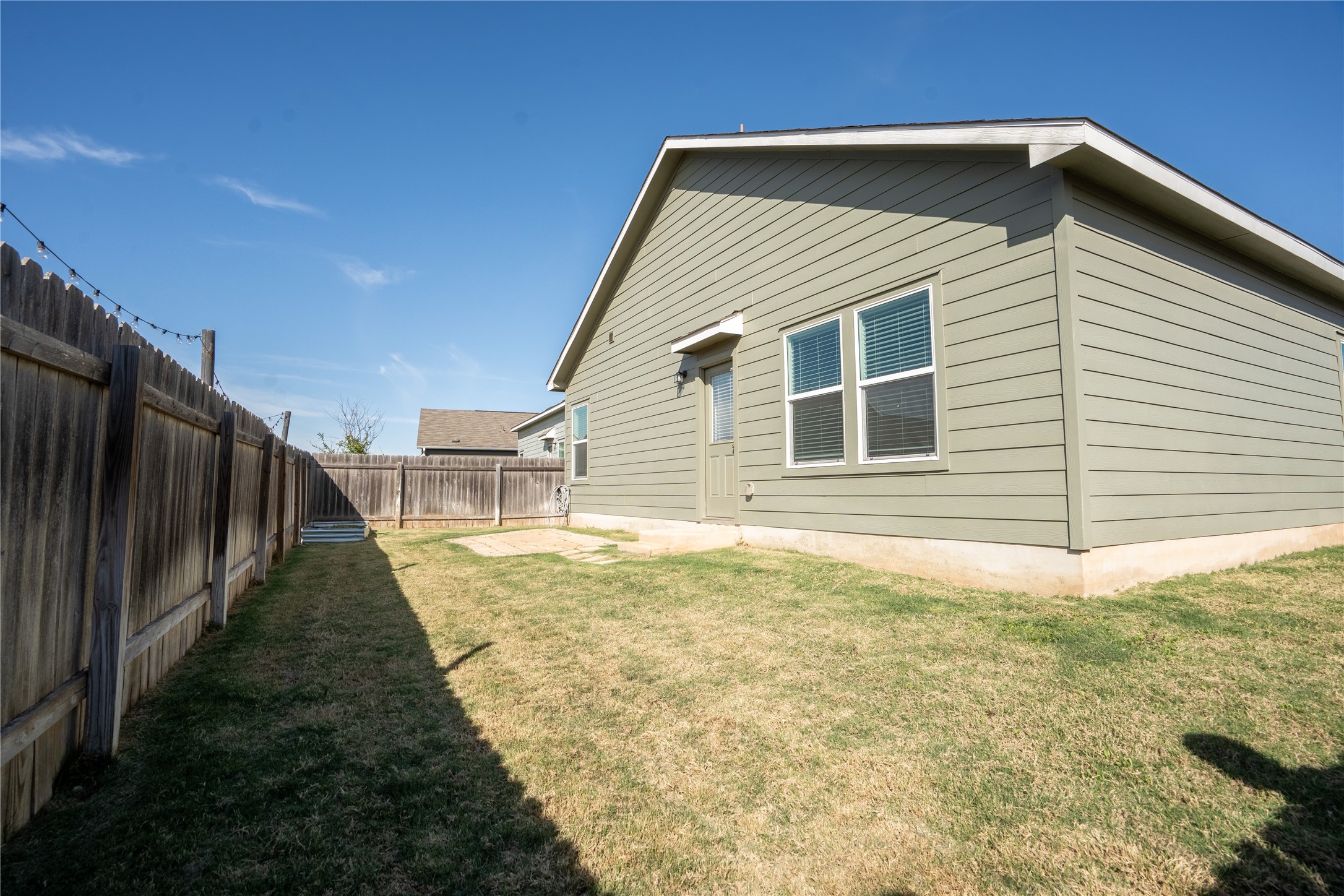 13400 Banquete Street Elgin, TX 78621 - Photo 26 of 29 Back of house with a fenced backyard and a patio
