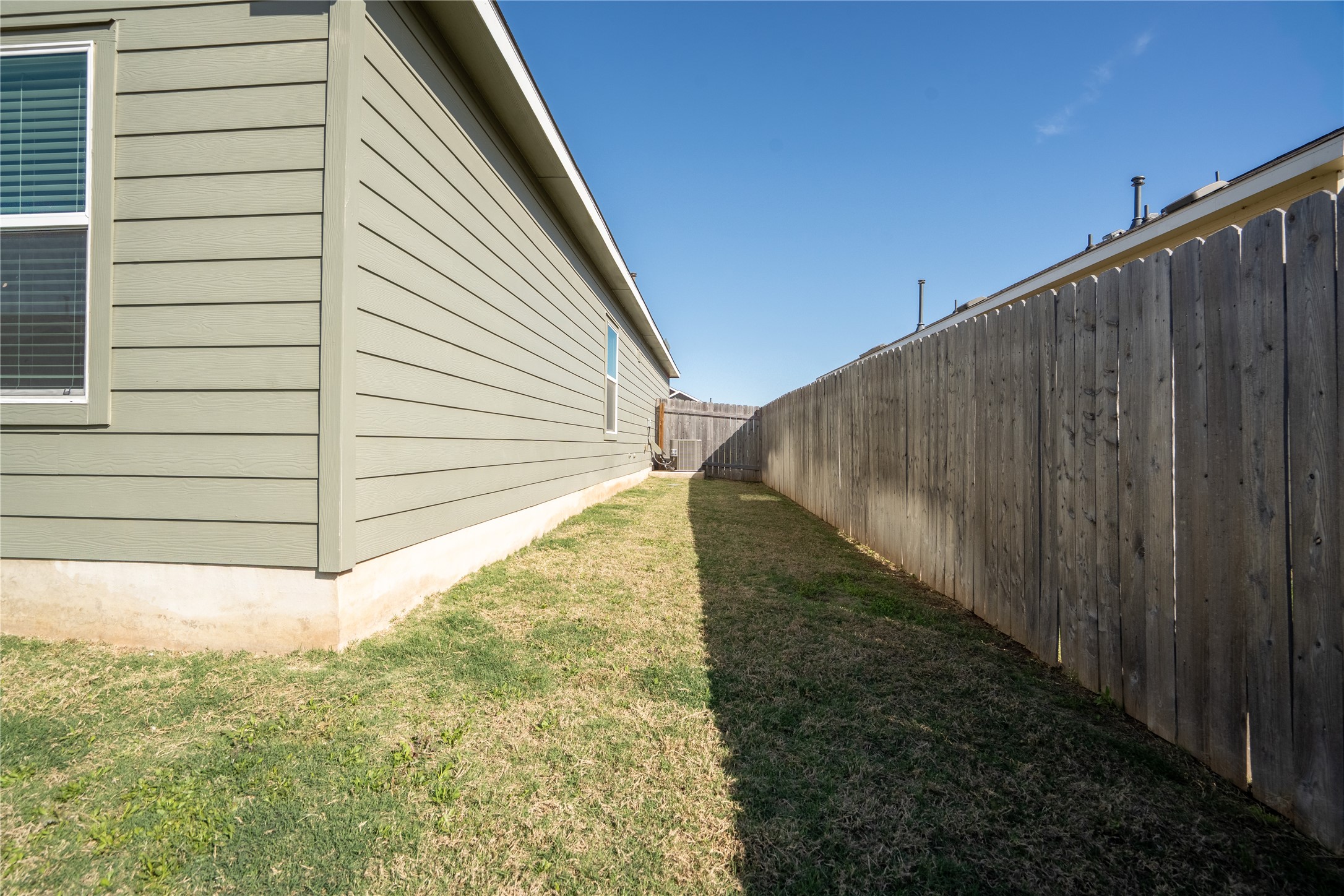 13400 Banquete Street Elgin, TX 78621 - Photo 27 of 29 View of side of home with a fenced backyard