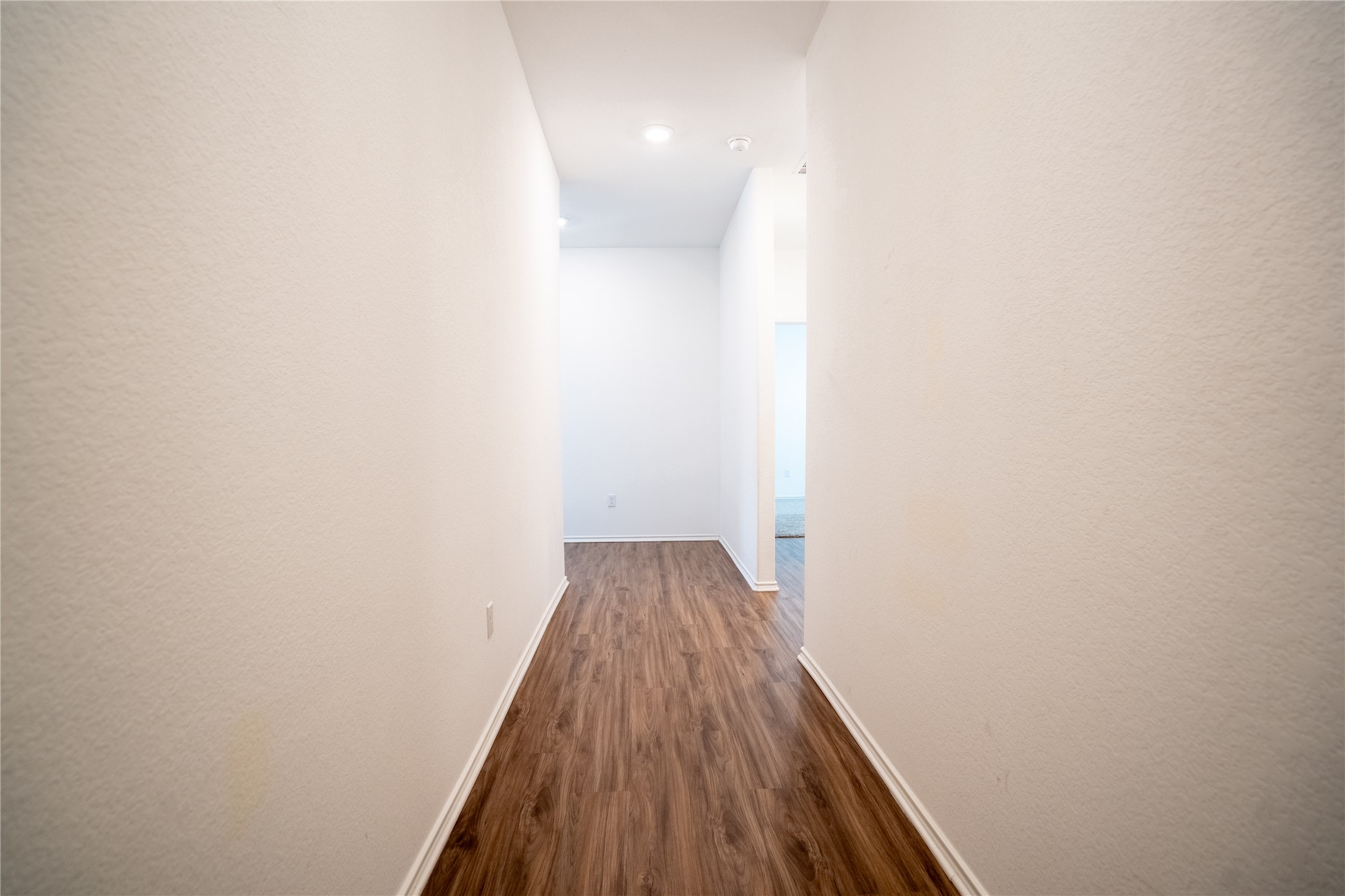 13400 Banquete Street Elgin, TX 78621 - Photo 5 of 29 Hall featuring baseboards and dark wood finished floors