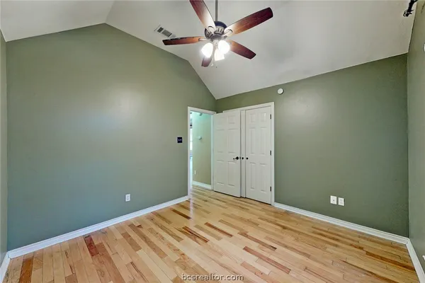 a view of a room with a ceiling fan