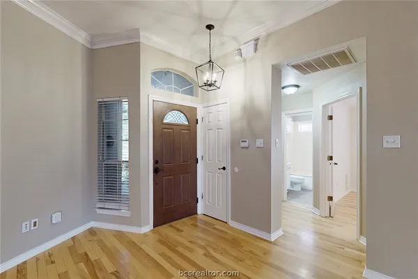 a bedroom with windows and entrance