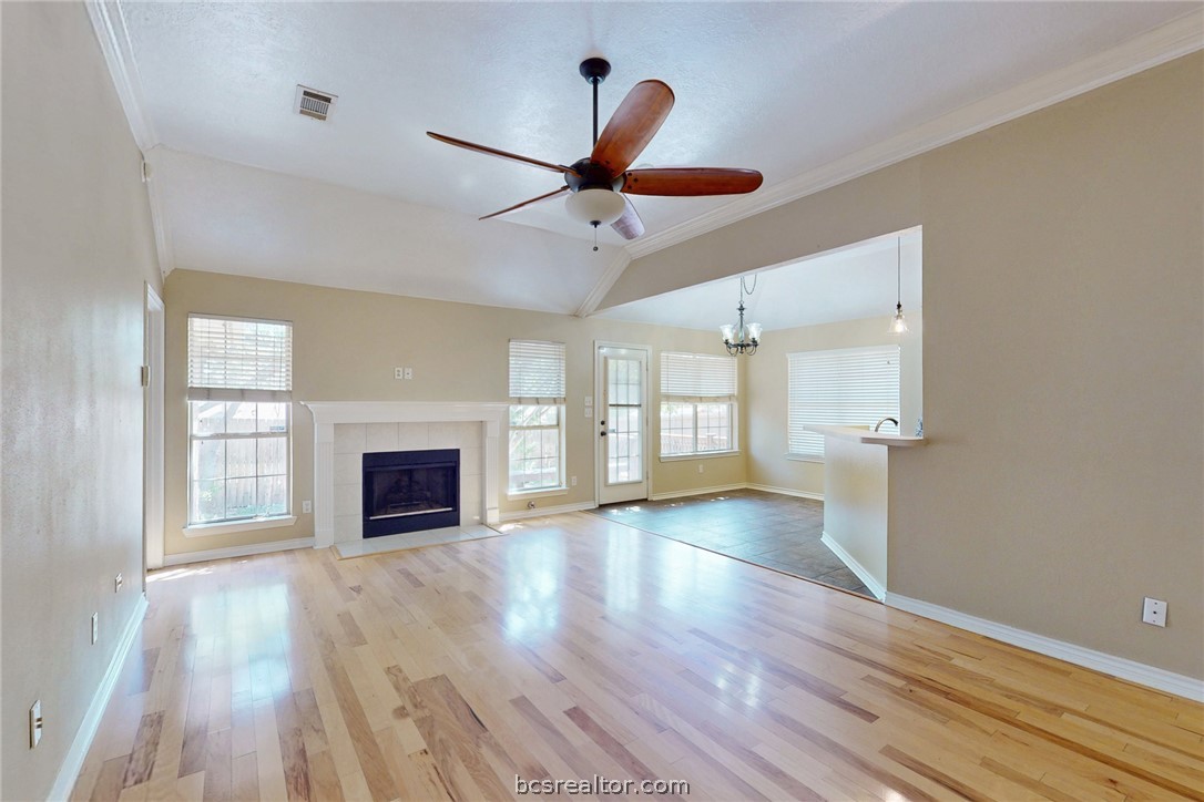 2817 Brandywine Circle Bryan, TX 77807 - Photo 4 of 28 wooden floor fireplace and windows in an empty room