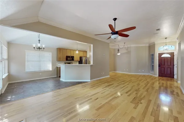 a view of a kitchen with a sink and a chandelier fan