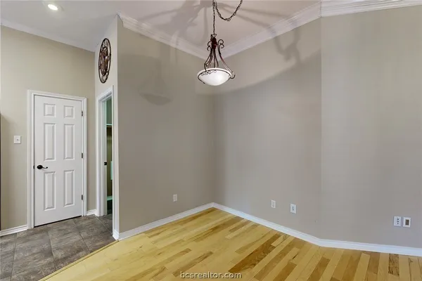 a view of a room with wooden floor