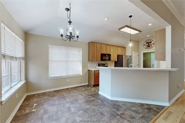 a view of a kitchen with furniture and windows