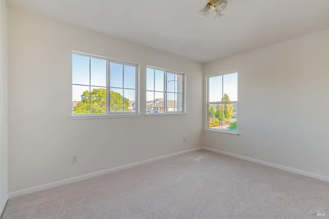 an empty room with window and windows