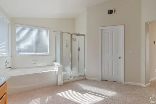 a bathroom with a bathtub a shower and a sink