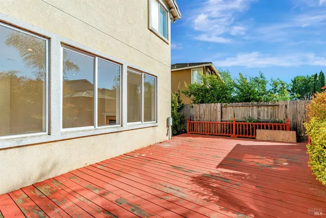 a view of backyard with wooden floor and outdoor seating