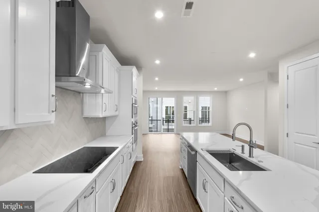 a kitchen with counter top space a sink and appliances