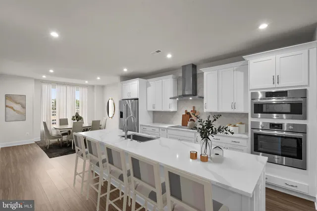 a kitchen with stainless steel appliances kitchen island granite countertop a sink and cabinets