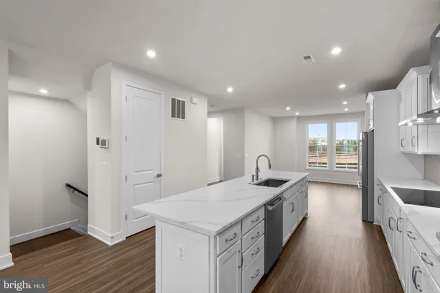 a kitchen with a sink and a refrigerator