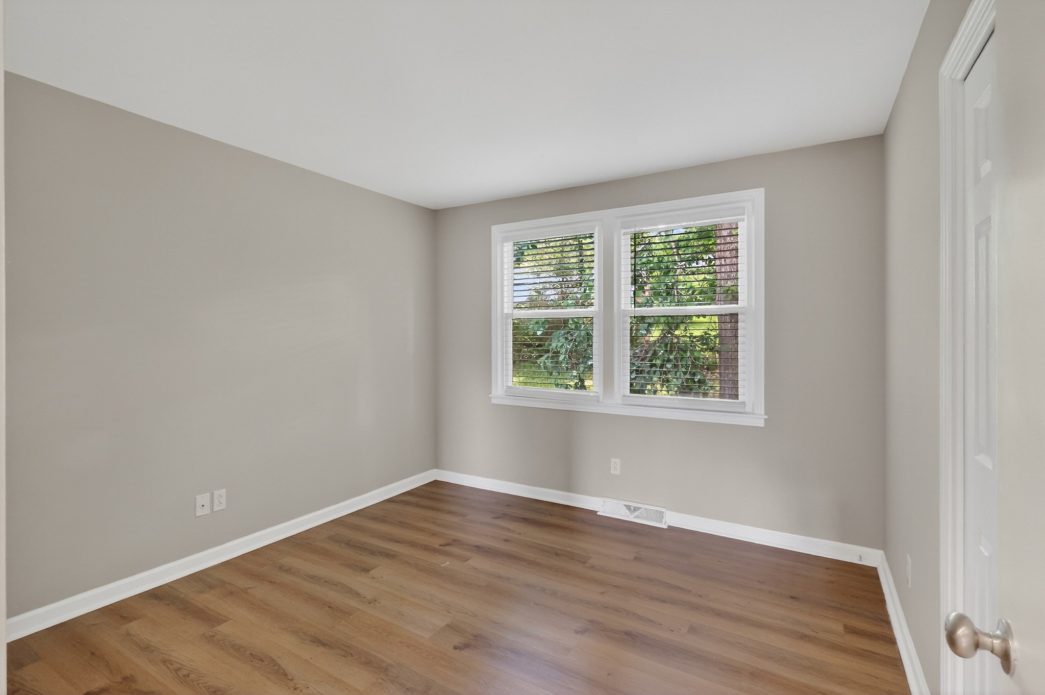 489 Canton Pass Madison, TN 37115 - Photo 11 of 25 an empty room with wooden floor and windows