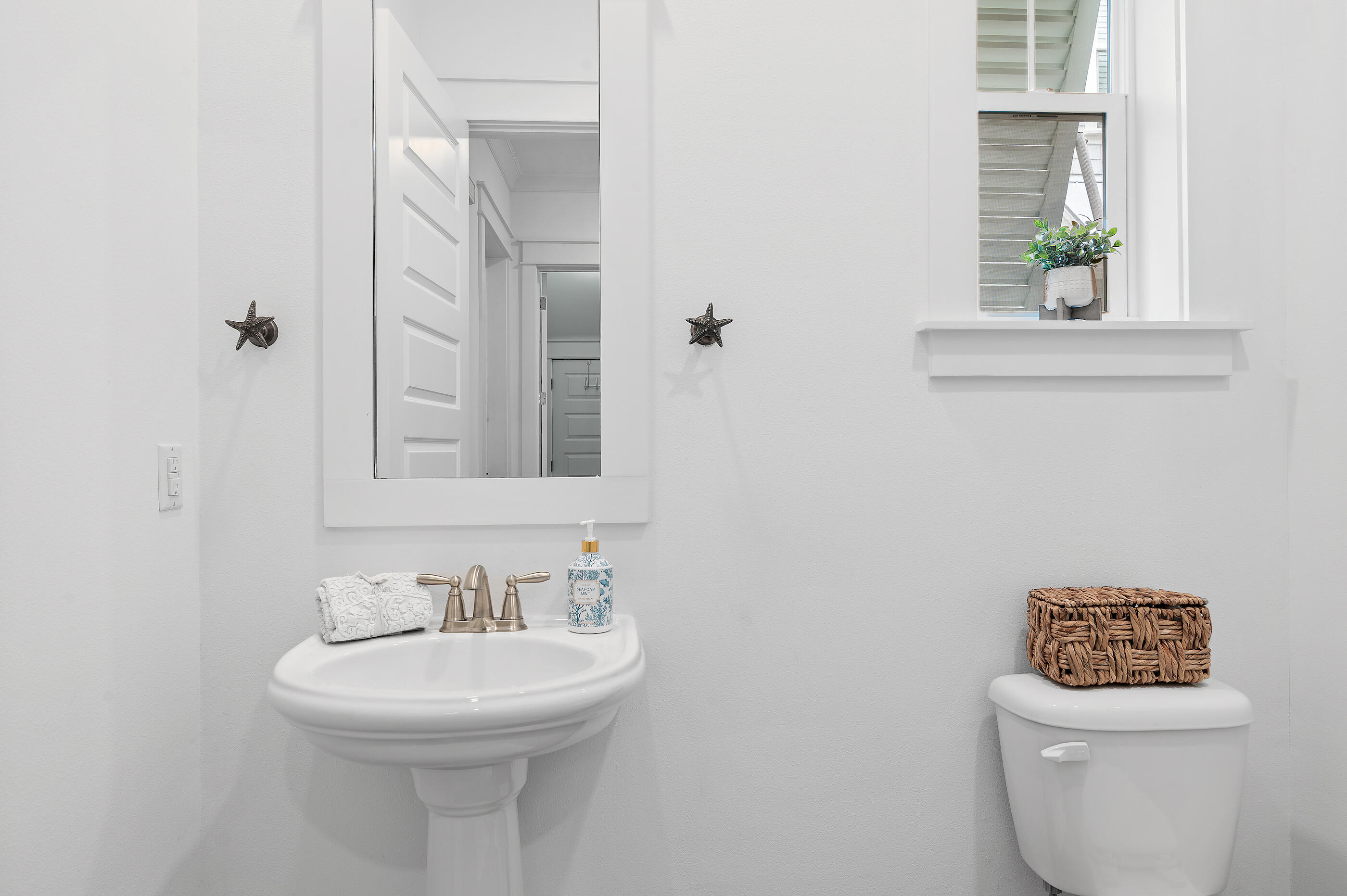 25 Pine Lands Loop East, Unit A Inlet Beach, FL 32461 - Photo 11 of 30 a bathroom with a toilet sink and mirror