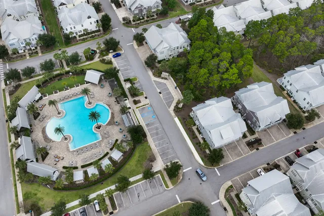a view of a brick house with large windows and a table and chairs
