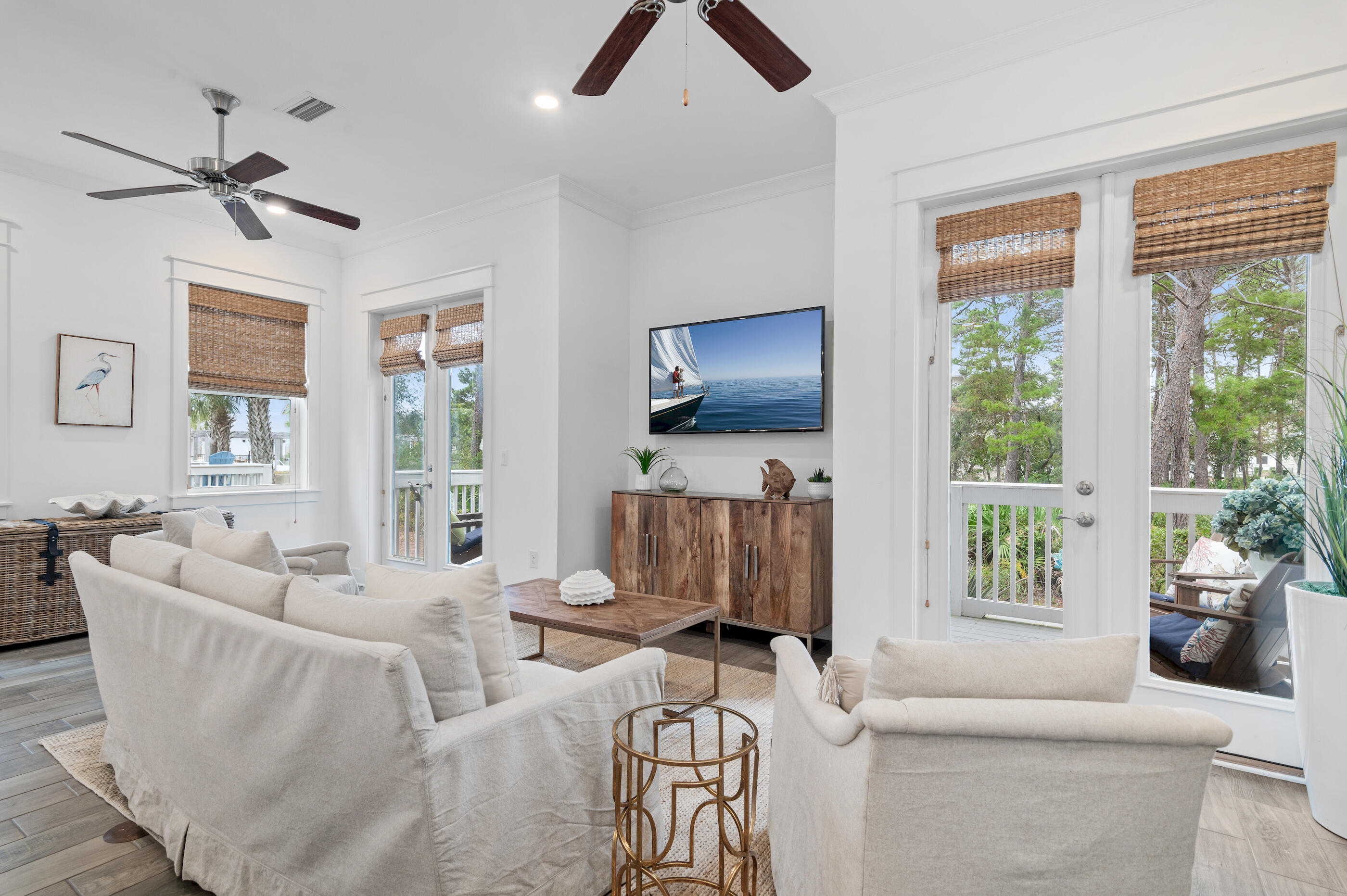 25 Pine Lands Loop East, Unit A Inlet Beach, FL 32461 - Photo 3 of 30 a living room with furniture a flat screen tv and a large window