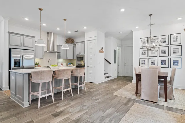 a kitchen with stainless steel appliances granite countertop a sink a stove and a refrigerator