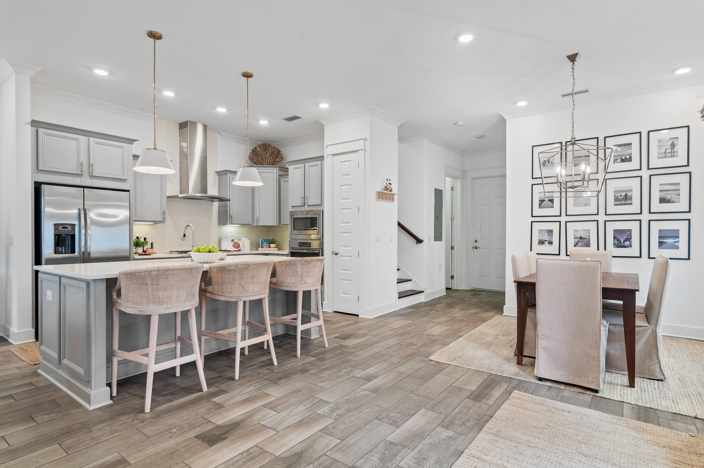 25 Pine Lands Loop East, Unit A Inlet Beach, FL 32461 - Photo 5 of 30 a kitchen with stainless steel appliances granite countertop a dining table chairs refrigerator and cabinets