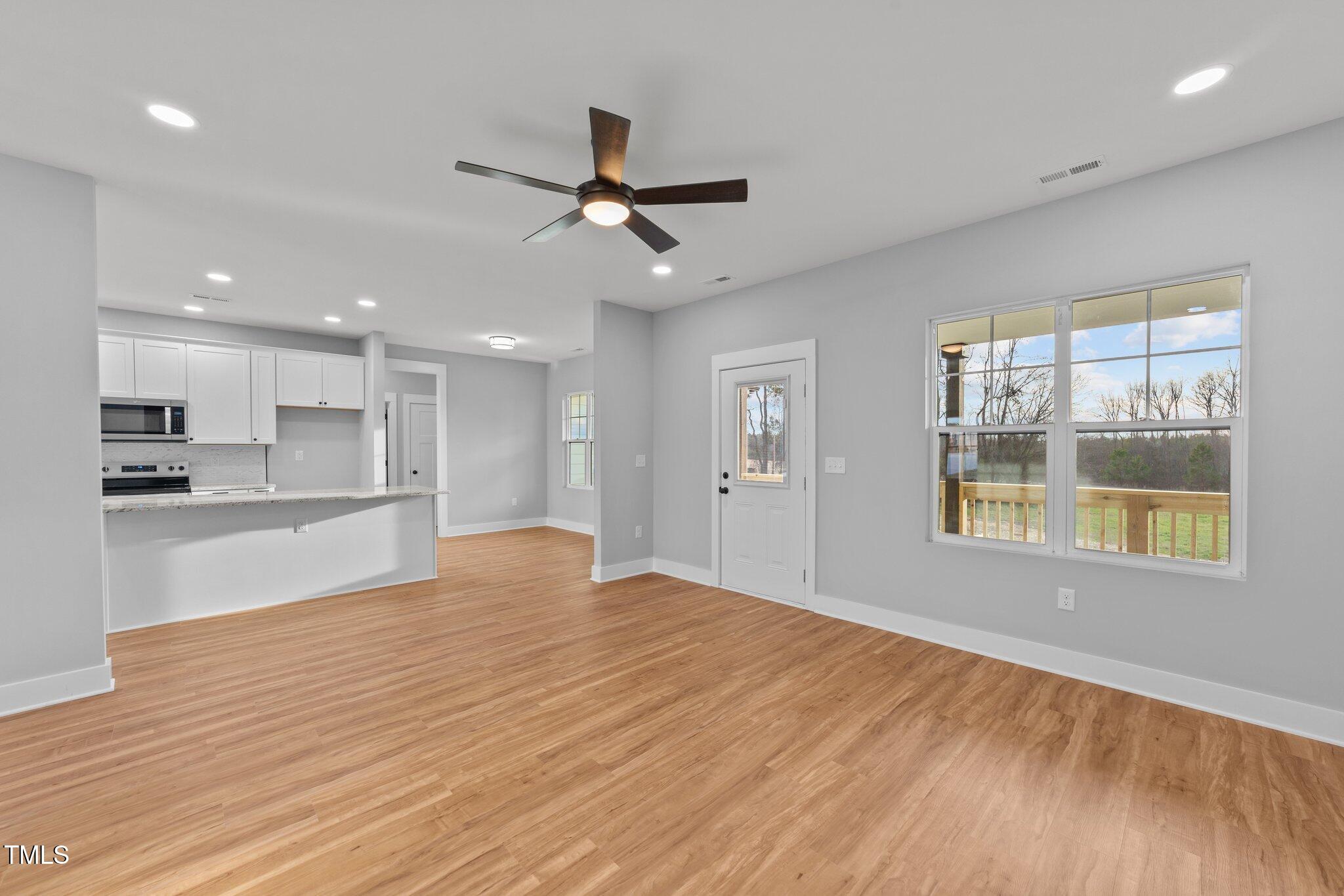 2955 Mt Pleasant Road Willow Spring, NC 27592 - Photo 11 of 44 a view of an empty room with window and wooden floor