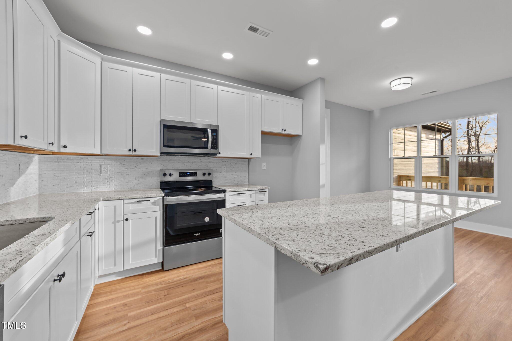 2955 Mt Pleasant Road Willow Spring, NC 27592 - Photo 13 of 44 a kitchen with granite countertop wooden cabinets and a granite counter tops
