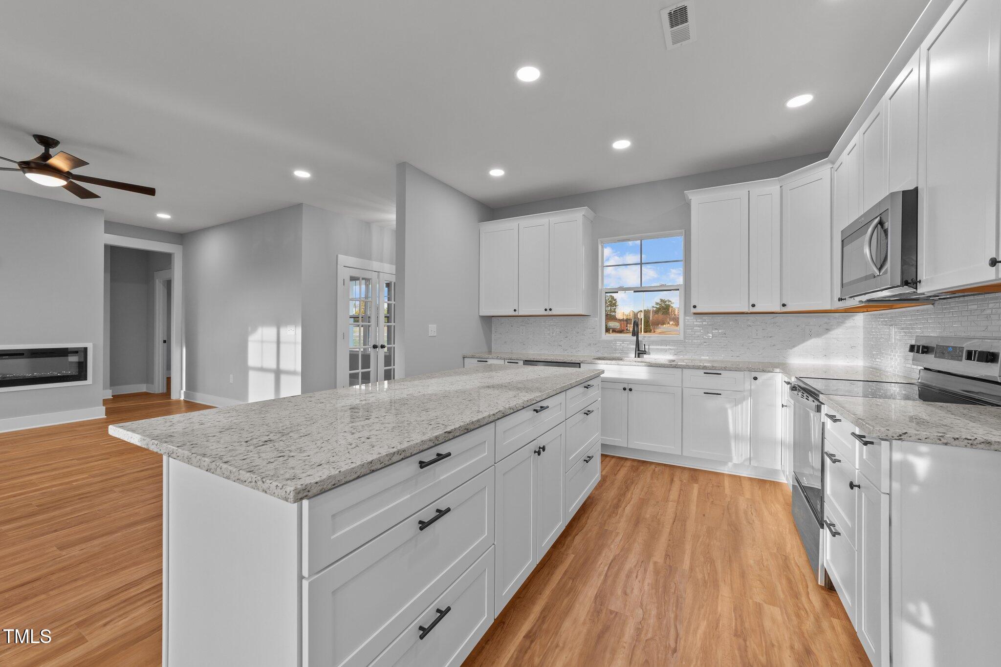 2955 Mt Pleasant Road Willow Spring, NC 27592 - Photo 15 of 44 a kitchen with a sink stove and cabinets