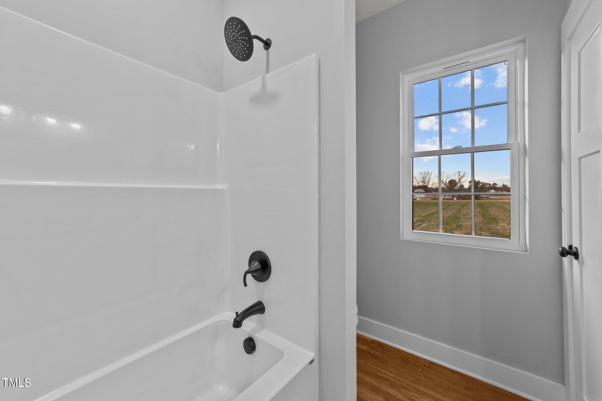 2955 Mt Pleasant Road Willow Spring, NC 27592 - Photo 19 of 44 a bathroom with a bathtub and shower