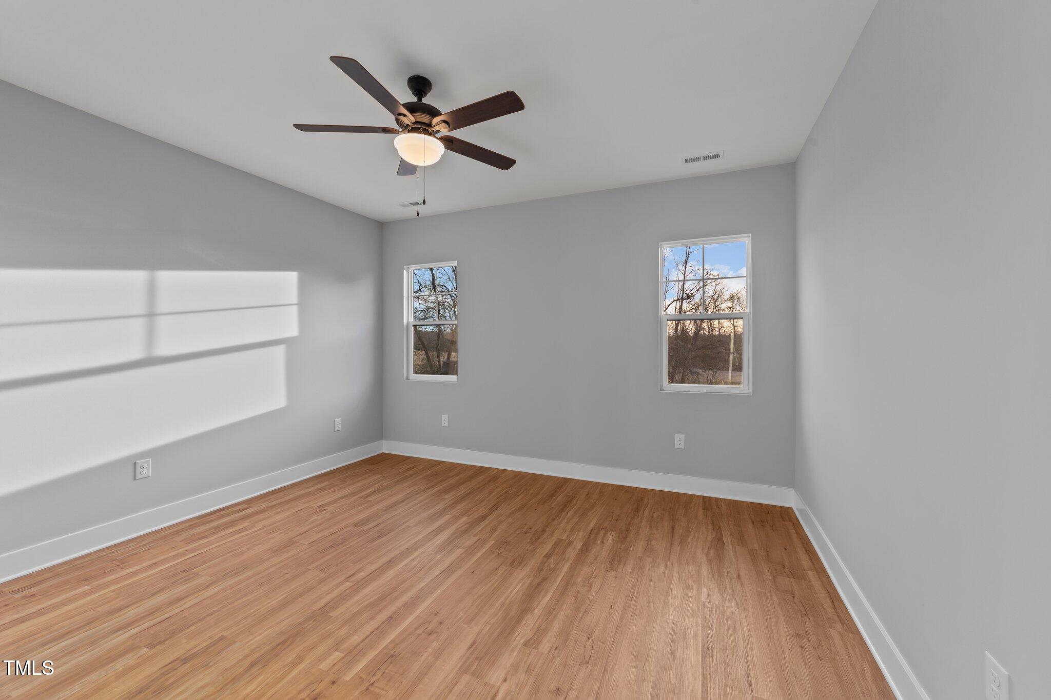 2955 Mt Pleasant Road Willow Spring, NC 27592 - Photo 23 of 44 wooden floor in an empty room with a window