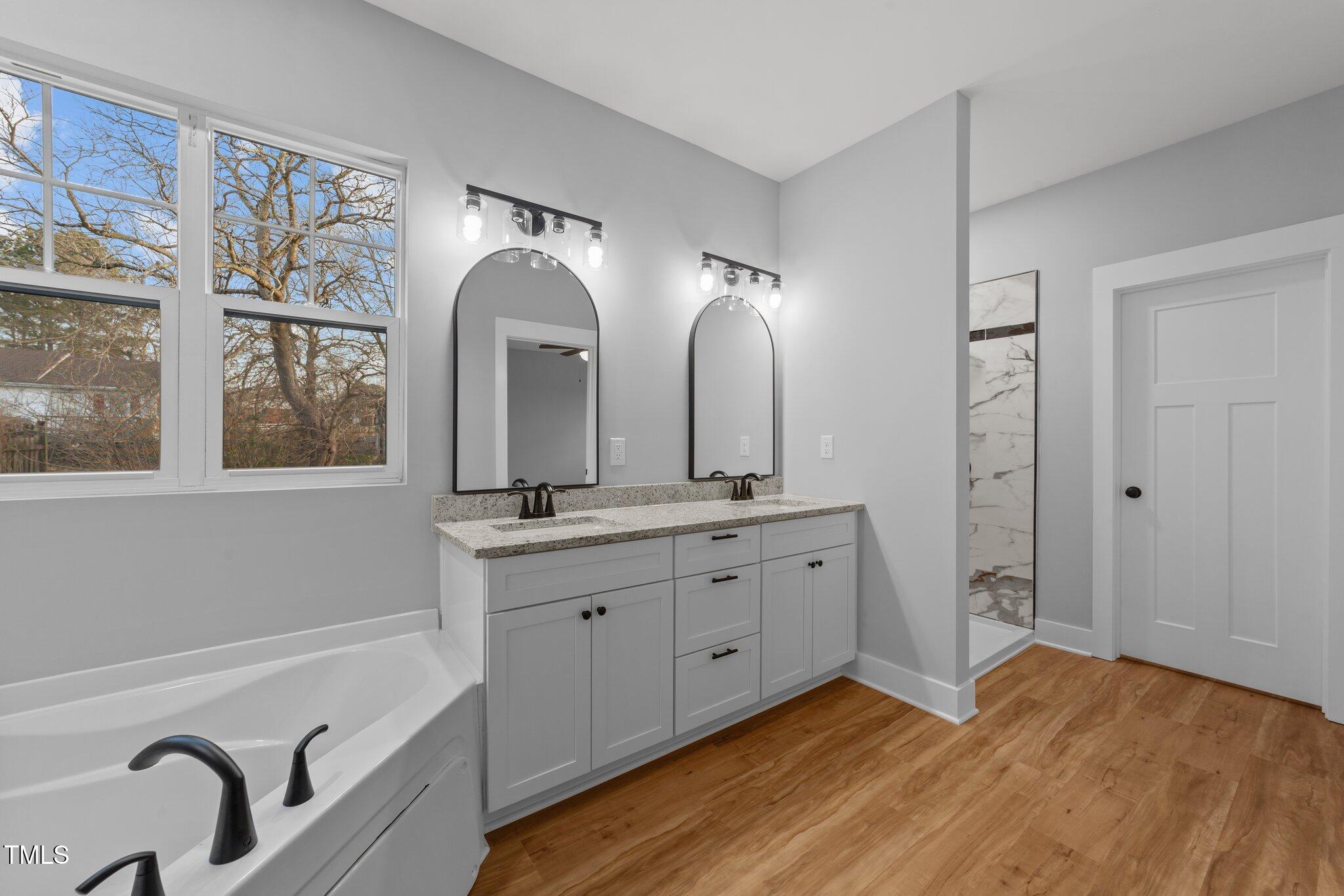 2955 Mt Pleasant Road Willow Spring, NC 27592 - Photo 29 of 44 a spacious bathroom with double vanity and a mirror
