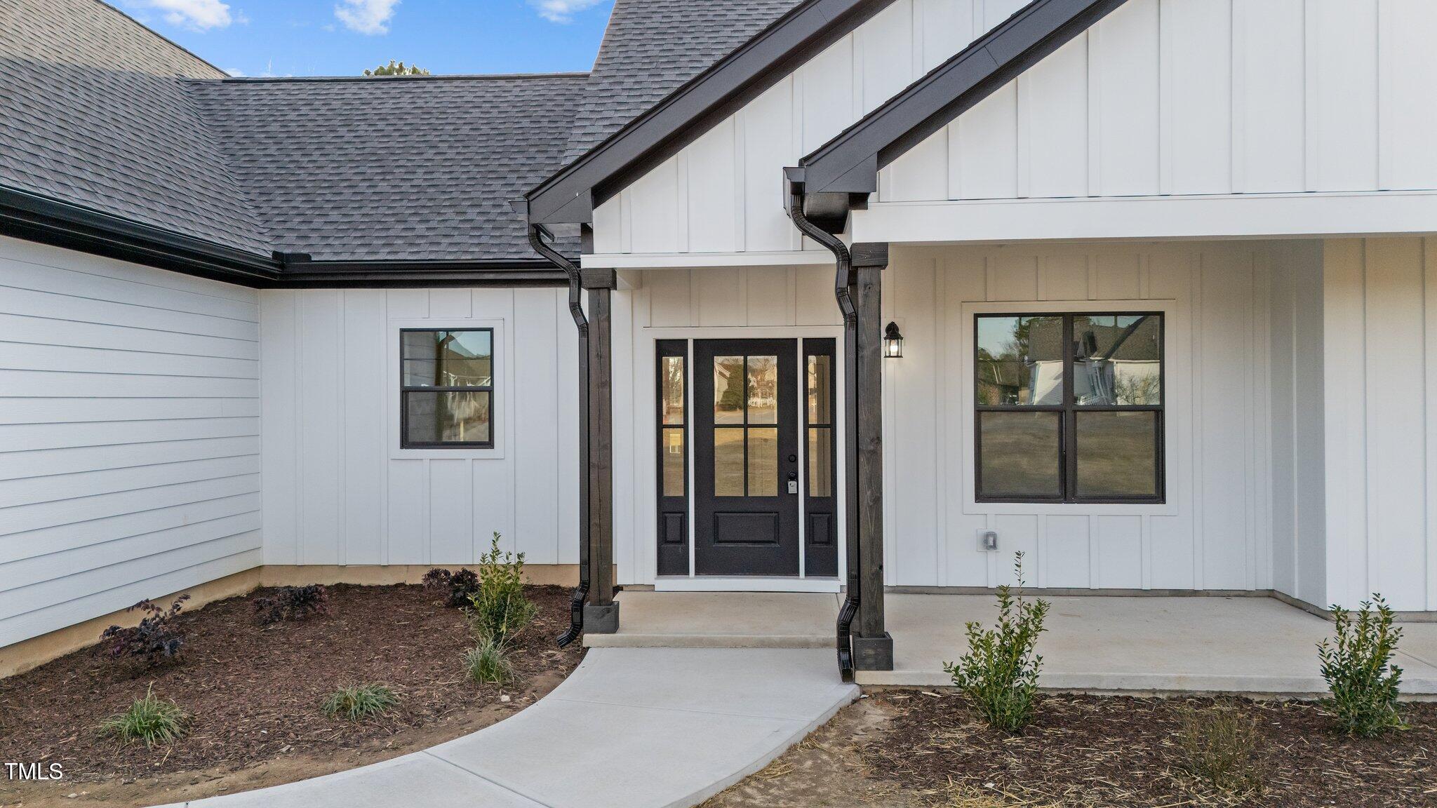2955 Mt Pleasant Road Willow Spring, NC 27592 - Photo 4 of 44 a front view of a house with a yard