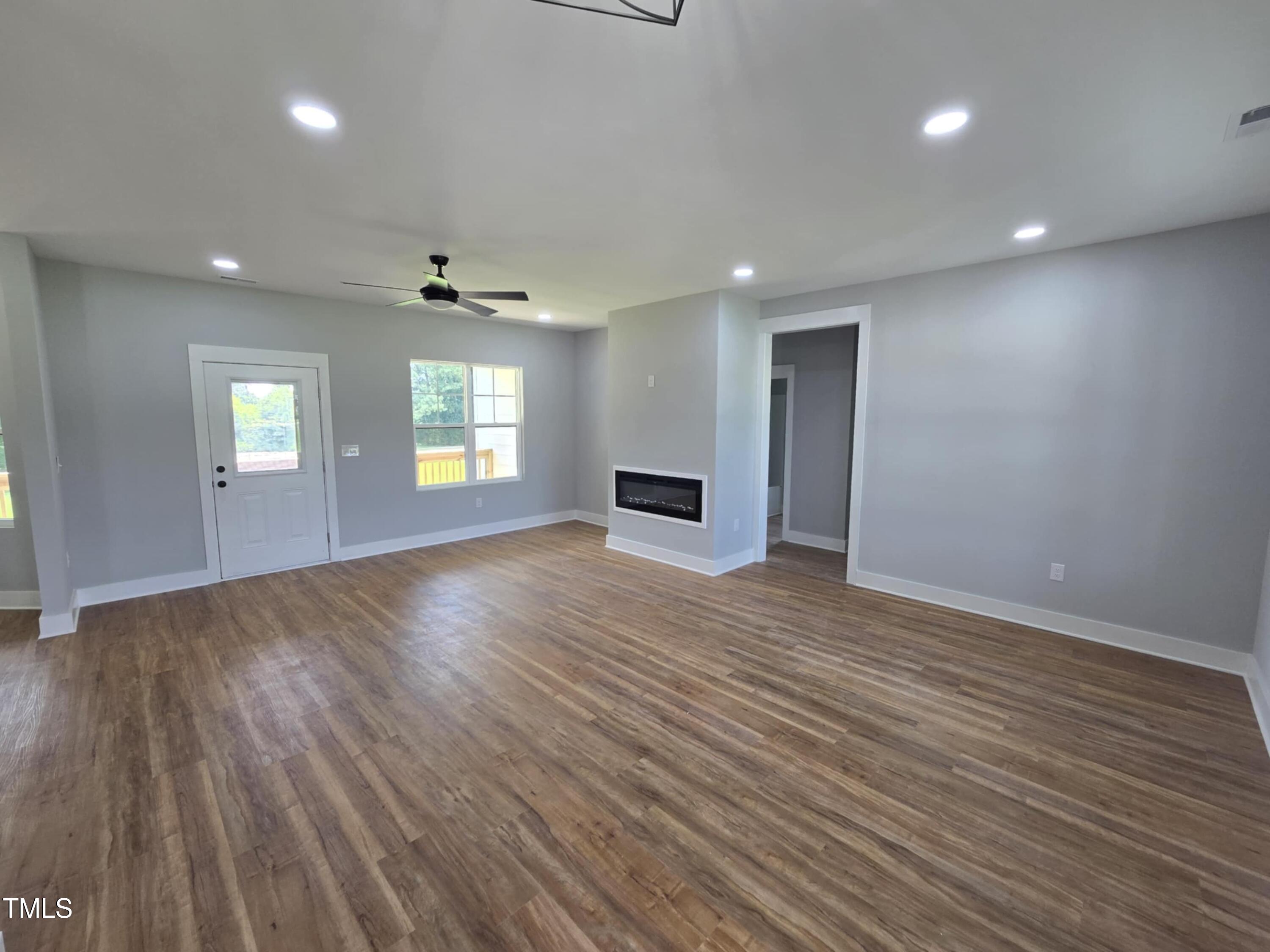 2955 Mt Pleasant Road Willow Spring, NC 27592 - Photo 6 of 44 an empty room with wooden floor and windows