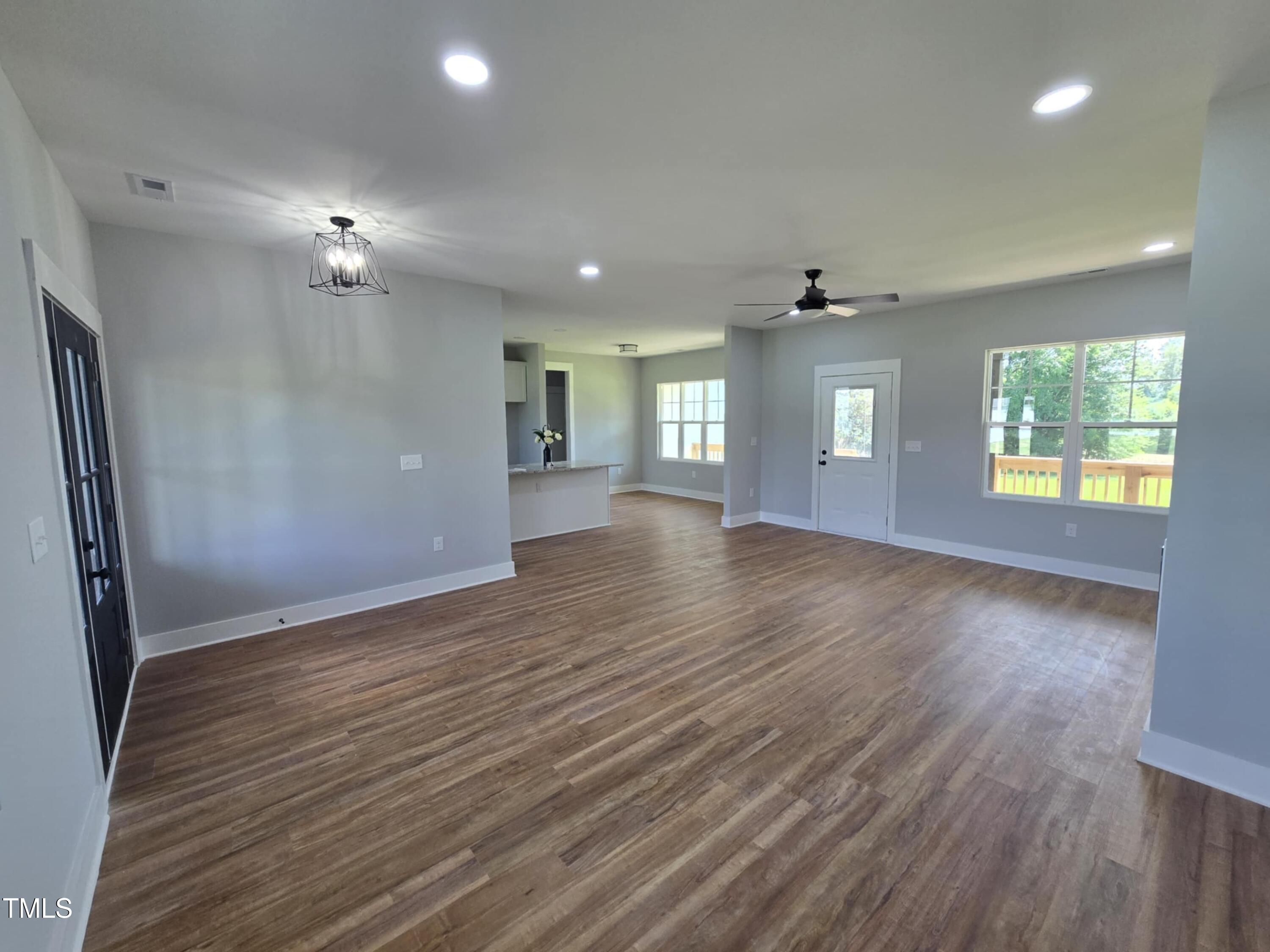 2955 Mt Pleasant Road Willow Spring, NC 27592 - Photo 7 of 44 an empty room with wooden floor and windows