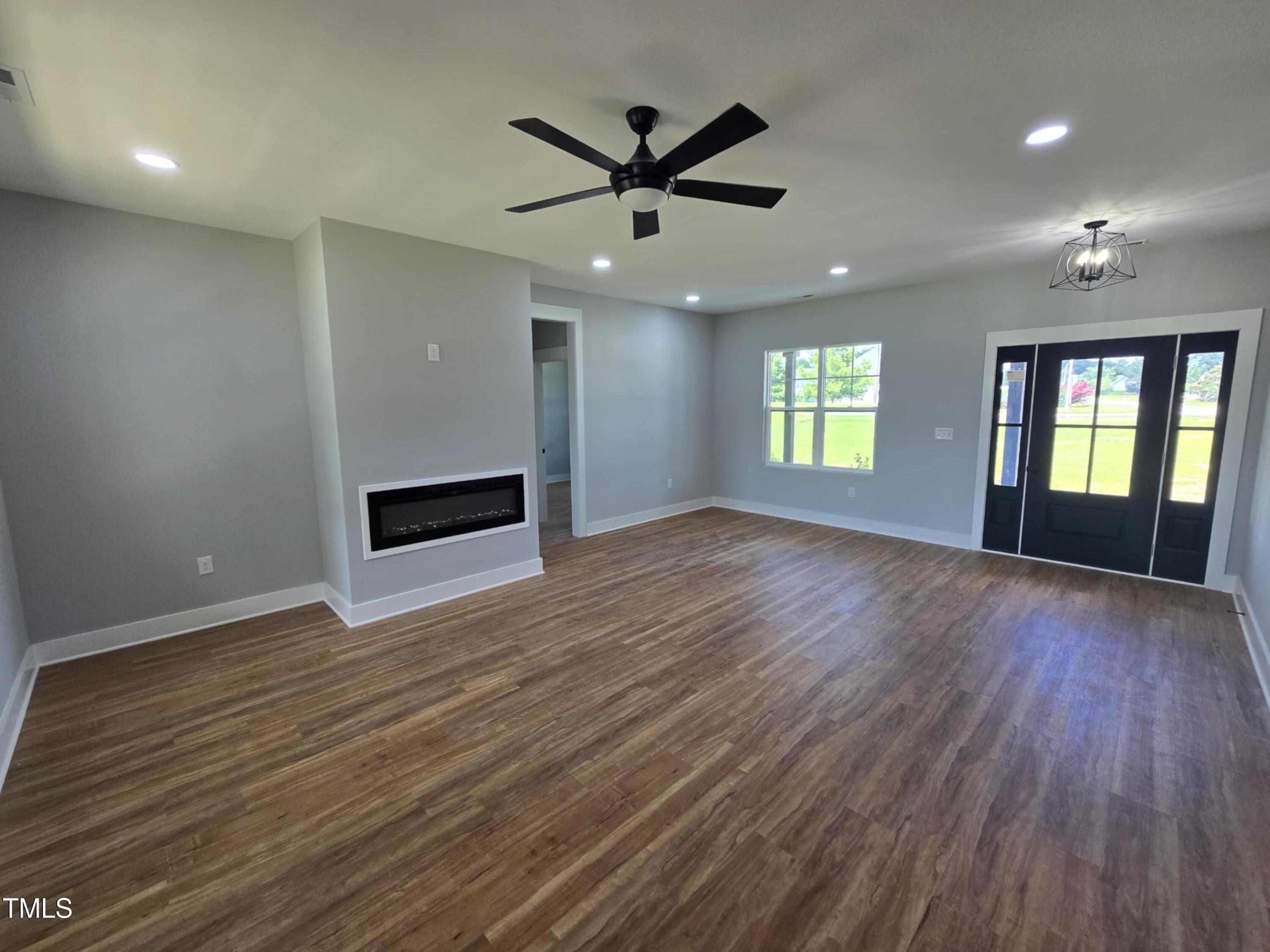 2955 Mt Pleasant Road Willow Spring, NC 27592 - Photo 9 of 44 an empty room with wooden floor and windows