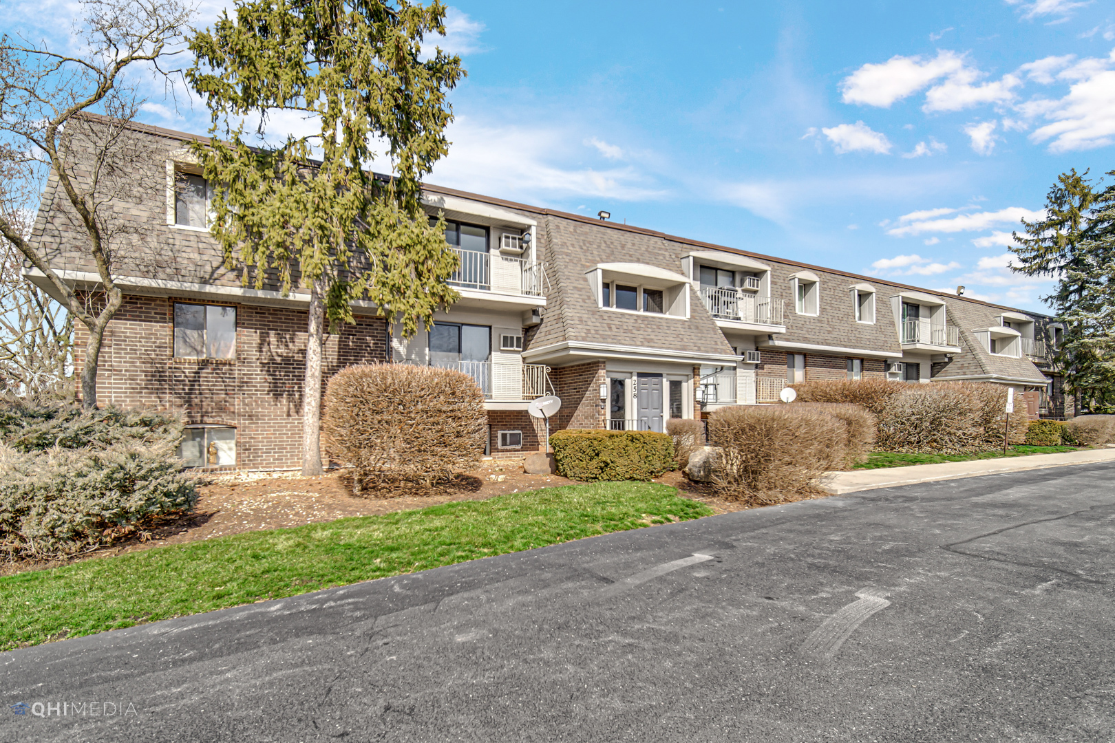 258 East Bailey Road, Unit J Naperville, IL 60565 - Photo 2 of 22 a front view of a house with garden