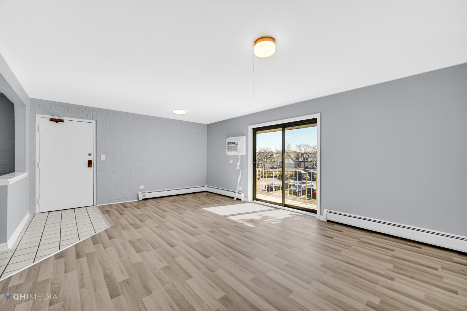 258 East Bailey Road, Unit J Naperville, IL 60565 - Photo 3 of 22 a view of an empty room with wooden floor and a window
