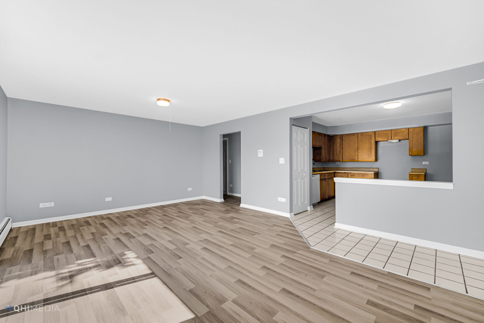258 East Bailey Road, Unit J Naperville, IL 60565 - Photo 4 of 22 a view of a kitchen with wooden floor and a refrigerator