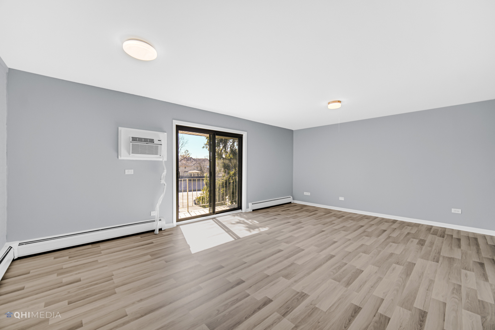 258 East Bailey Road, Unit J Naperville, IL 60565 - Photo 5 of 22 an empty room with wooden floor and windows