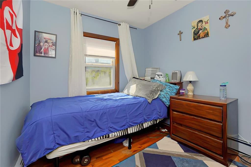 2318 Knapp Street Brooklyn, NY 11229 - Photo 15 of 32 a bedroom with a bed and painting on the wall