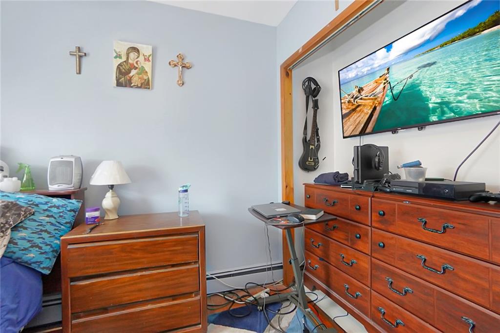 2318 Knapp Street Brooklyn, NY 11229 - Photo 16 of 32 a bedroom with a bed and a dresser in it