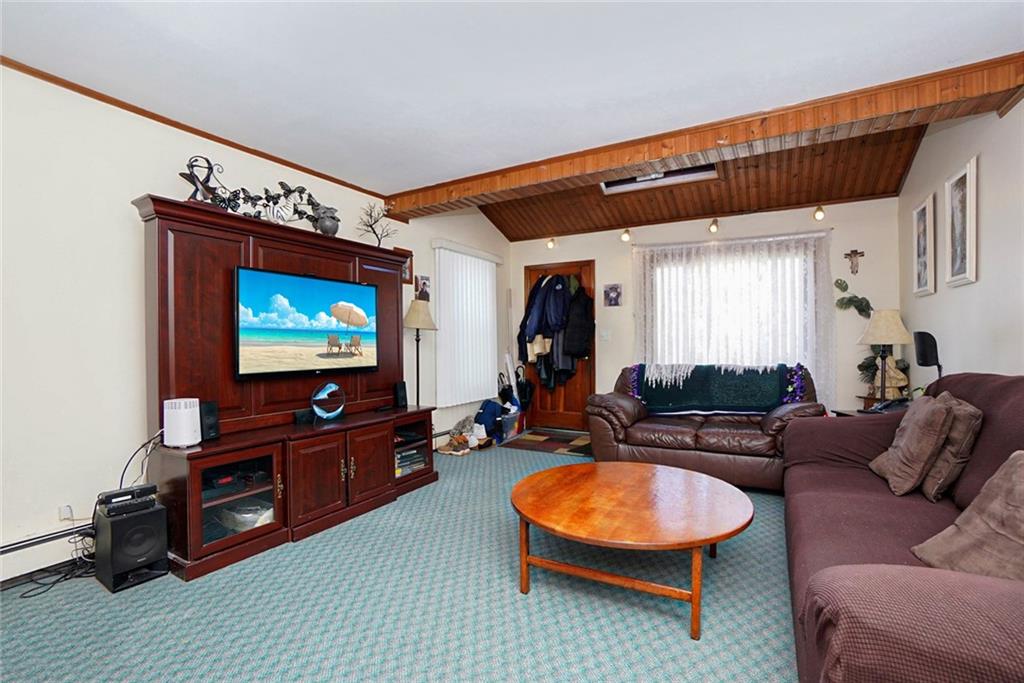 2318 Knapp Street Brooklyn, NY 11229 - Photo 4 of 32 a living room with furniture and a flat screen tv