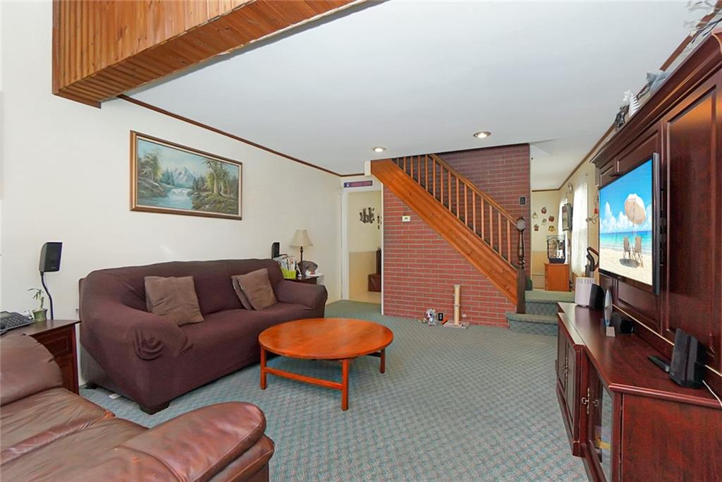 2318 Knapp Street Brooklyn, NY 11229 - Photo 5 of 32 a living room with furniture and a flat screen tv