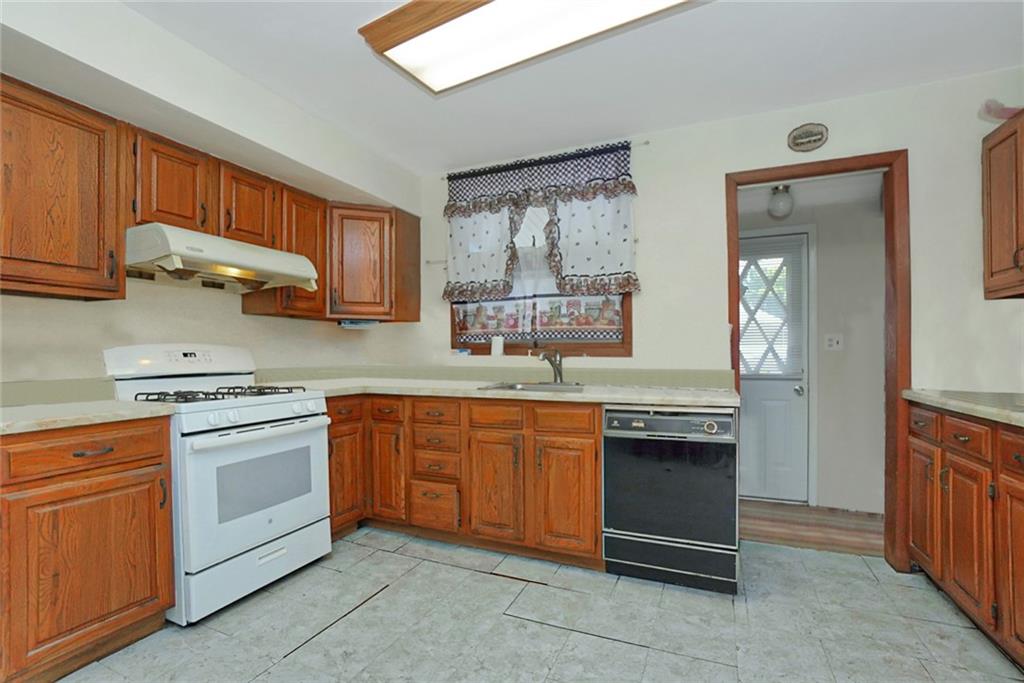 2318 Knapp Street Brooklyn, NY 11229 - Photo 9 of 32 a kitchen with stainless steel appliances granite countertop a stove sink and cabinets